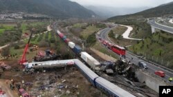 A train carrying hundreds of passengers has collided with an oncoming freight train in northern Greece, killing and injuring dozens of passengers. (AP Photo/Vaggelis Kousioras)