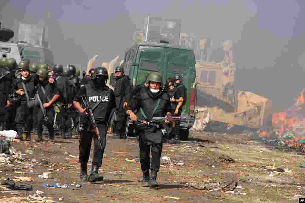 Egyptian security forces clear a sit-in by supporters of ousted Islamist President Mohammed Morsi in the eastern Nasr City district of Cairo, Egypt, Wednesday, Aug. 14, 2013. Egyptian security forces, backed by armored cars and bulldozers, moved on Wednes