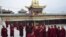 Tibetan monks prepare to attend a prayer meeting for tourists at a temple in Huangnan Tibetan Autonomous Prefecture, Qinghai province, China, July 19, 2012.