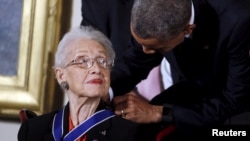 FILE - U.S. President Barack Obama presents the Presidential Medal of Freedom to NASA mathematician Katherine G. Johnson during an event in the East Room of the White House in Washington November 24, 2015. 