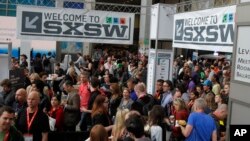 FILE - SXSW Interactive and Film Festival attendees crowd the Austin Convention Center in Austin, Texas. 