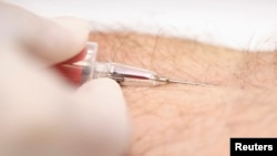 FILE - A nurse draws a blood sample for a free HIV test during a blood tests campaign to prevent HIV infection, Sept. 20, 2014. 