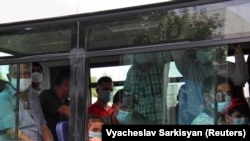 People wearing protective face masks are seen inside a bus in Ashgabat, Turkmenistan, July 15, 2020. (REUTERS/Vyacheslav Sarkisyan)