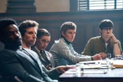 This image released by Netflix shows, from left, Yahya Abdul-Mateen, Ben Shenkman, Mark Rylance, Eddie Redmayne and Alex Sharp in a scene from "The Trial of the Chicago 7."