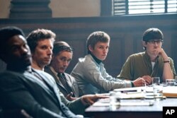 This image released by Netflix shows, from left, Yahya Abdul-Mateen, Ben Shenkman, Mark Rylance, Eddie Redmayne and Alex Sharp in a scene from "The Trial of the Chicago 7."