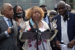 FILE - Gwen Carr, the mother of Eric Garner, addresses media at the public viewing of George Floyd, in Houston, Texas, June 8, 2020. Standing on the left is the Reverend Al Sharpton and on the right is attorney Ben Crump.