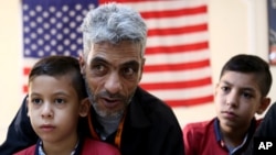 Syrian refugee Nadim Fawzi Jouriyeh, 49, speaks to reporters at the Amman, Jordan office of the International Organization for Migration, Aug. 28, 2016.