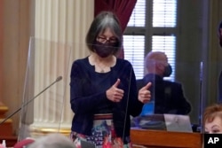State Sen. Nancy Skinner, D-Berkeley, praises a colleague after lawmakers passed state budget bills at the Capitol in Sacramento, Calif., July 15, 2021. Among bills approved was the nation's first state-funded guaranteed income plan.