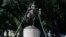 Workers inspect a statue of Robert E. Lee in a public park in Dallas, Sept. 6, 2017. The Dallas City Council voted to remove the statue.