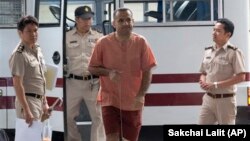 Atris Hussein, center, a Lebanese-Swedish citizen, arrives at criminal court in Bangkok, Thailand, Wednesday, Sept. 18, 2013. The court convicted Hussein of illegal possession of bomb-making materials that he was storing in a warehouse outside Bangkok. Hu