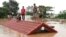 Villagers take refuge on a rooftop above flood waters from a collapsed dam in the Attapeu district of southeastern Laos, July 24, 2018. 