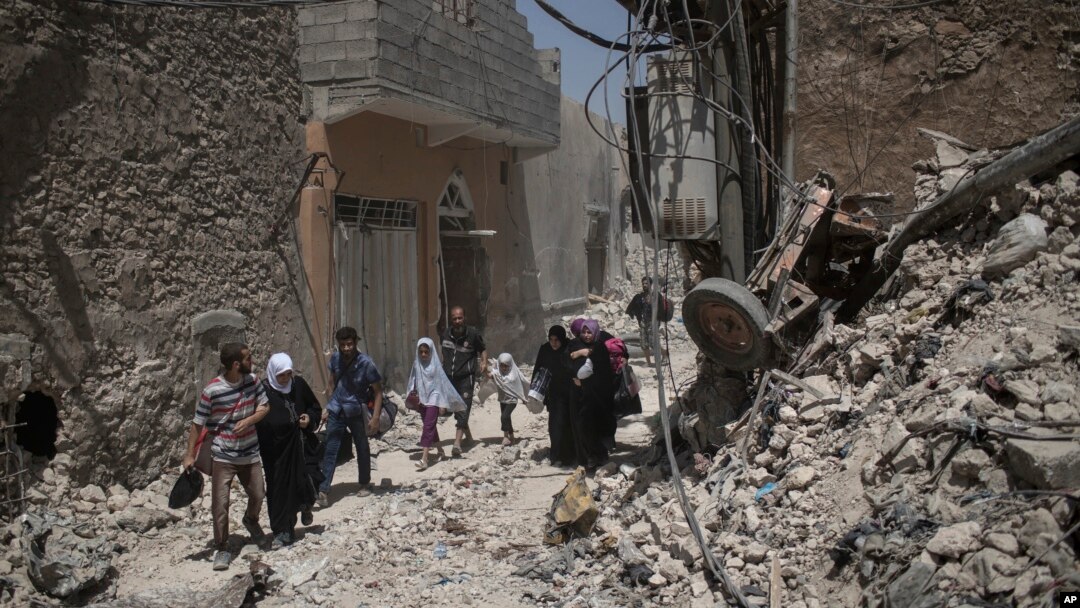 Warga sipil Irak meninggalkan tempat tinggalnya sementara Pasukan Khusus Irak terus bertempur melawan militan ISIS di Kota Tua Mosul, Irak, 29 JUni 2017. 