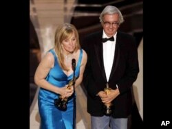 FILE - Diana Ossana and Larry McMurtry accept the Oscar for best adapted screenplay for their work on "Brokeback Mountain" at the 78th Academy Awards in Los Angeles, March 5, 2006.