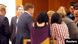 Leader of the Christian Democratic Union (CDU) Angela Merkel is seen talking with members of the Green Party during exploratory talks about forming a new coalition government in Berlin, Germany, Nov. 19, 2017. Picture was taken through a window.