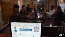 FILE - In this photo taken on Feb. 6, 2019, the Twitter page of Taliban spokesman Zabihullah Mujahid is pictured on a computer monitor in the newsroom at Maiwand TV station in Kabul. 