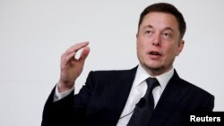 FILE - Elon Musk, co-founder of Tesla, speaks at a conference in Washington, July 19, 2017. Musk announced Friday that Tesla will remain a publicly traded company. 