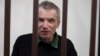 (FILE) Imprisoned Kremlin critic Alexei Gorinov, sits in a cage at the court in Vladimir, Russia, Friday, Nov. 29, 2024.