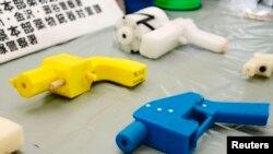 Seized plastic handguns which were created using 3D printing technology are displayed at Kanagawa police station in Yokohama, south of Tokyo, May 8, 2014.