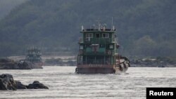 In this file photo, Chinese cargo ships sail on the Mekong river near the Golden Triangle at the border between Laos, Myanmar and Thailand March 1, 2016.