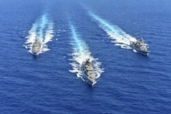 FILE - A handout picture from the Greek National Defense Ministry shows warships taking part in a military exercise at the eastern Mediteranean sea, Aug. 25, 2020.