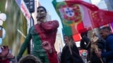 People gather for a statue unveiling in Times Square on the birthday of soccer star Cristiano Ronaldo in New York City, Feb. 5, 2025. 