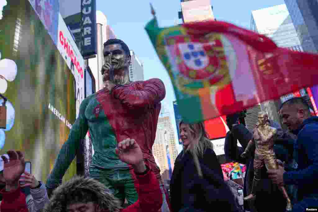 People gather for a statue unveiling in Times Square on the birthday of soccer star Cristiano Ronaldo in New York City.