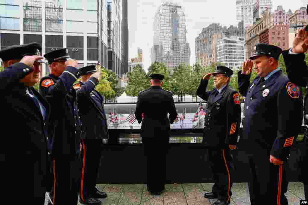 Fire Department of New York (FDNY) firefighters gather ahead of the the 25th anniversary commemoration of the September 11, 2001 attacks at the National September 11 Memorial in New York on September 11, 2026. (Photo by Jeenah Moon / POOL / AFP)