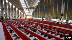 Muslims offer a prayer at the Grand Faisal Mosque in Islamabad amid the Covid-19 coronavirus pandemic, May 3, 2021.