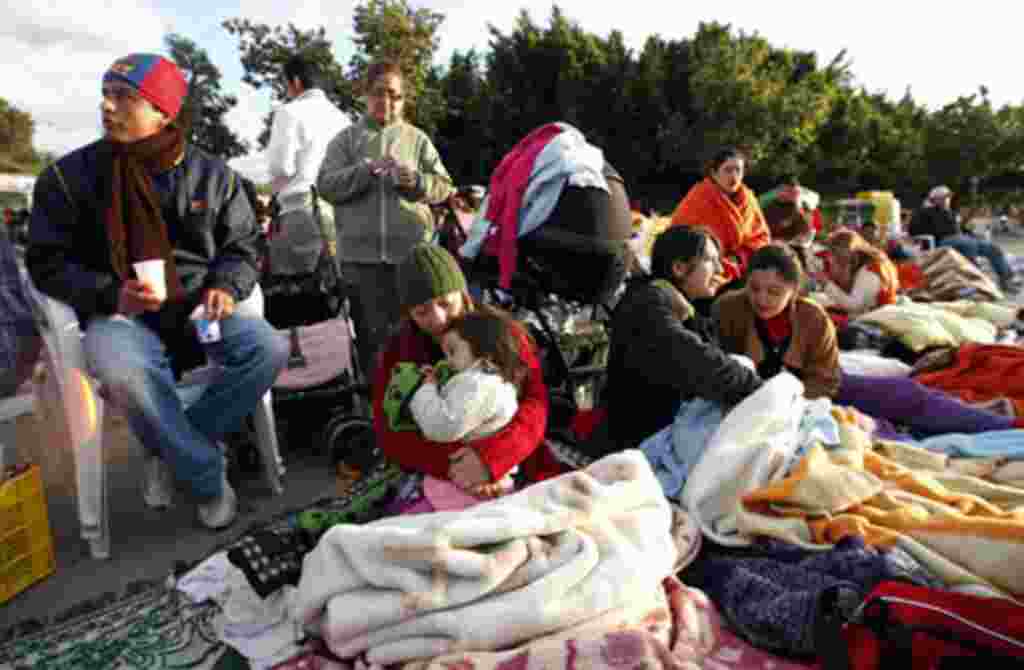 People wait to return to their homes after spending the night in the open following a rare earthquake that rocked the town of Lorca in southeastern Spain, May 12, 2011