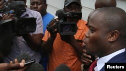 Political activist and leader of the Tajamuka/Sesjikile Movement Promise Mkwananzi speaks to the media outside the Constitutional Court in Harare, Zimbabwe, Feb. 8, 2017.