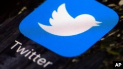 FILE - A Twitter app icon is pictured on a mobile phone. 