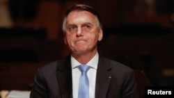 FILE - Brazil’s former President Jair Bolsonaro attends an event at the Municipal Theatre in Sao Paulo on March 25, 2024.