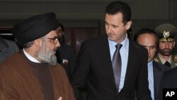 FILE -- Hezbollah leader sheik Hassan Nasrallah, left, speaks with Syrian President Bashar Assad on Feb 25, 2010. (AP Photo/SANA)