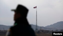 FILE - A North Korean flag flutters on top of a tower at the propaganda village of Gijungdong in North Korea, in this picture taken near the truce village of Panmunjom.