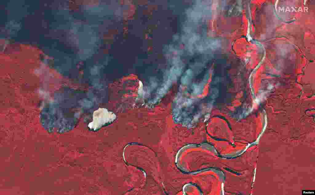 Smoke rises from wildfires near Berezovka River in Russia in this June 23, 2020 color infrared image provided by Maxar Technologies.