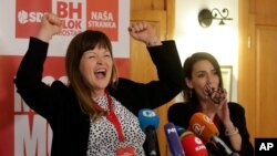 Irma Baralija greets supporters at her headquarters after local elections in Mostar, Bosnia, Sunday, Dec. 20, 2020.