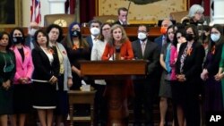 FILE - Texas state Rep. Donna Howard, D-Austin, center at lectern, speaks against a bill that would ban abortions as early as six weeks and allow private citizens to enforce it through civil lawsuits, in the House Chamber in Austin, Texas, May 5, 2021.