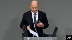 German Chancellor Olaf Scholz speaks during a plenary session at the German parliament before facing a no-confidence vote, in Berlin, Germany, Dec. 16, 2024.