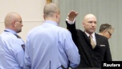 Mass killer Anders Behring Breivik raises his arm in a Nazi salute as he enters the court room in Skien prison, Norway, March 15, 2016.