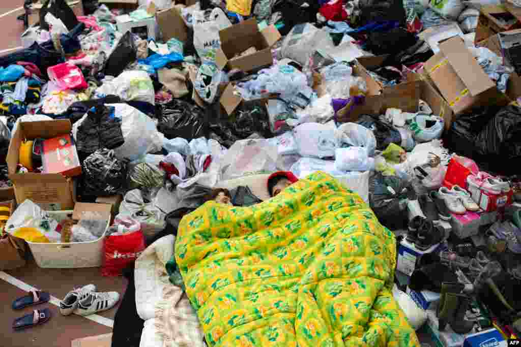 People surrounded by humanitarian supplies sleep at Bayrakli district in Izmir, after a 7.0-magnitude earthquake struck Turkey and Greece on Oct. 30.