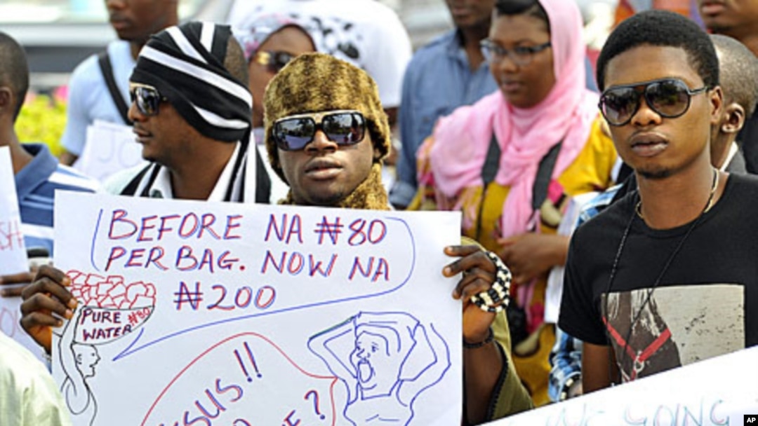 A protester carries a placard during a rally against fuel subsidy cuts in Nigeria's capital, Abuja, January 6, 2012.