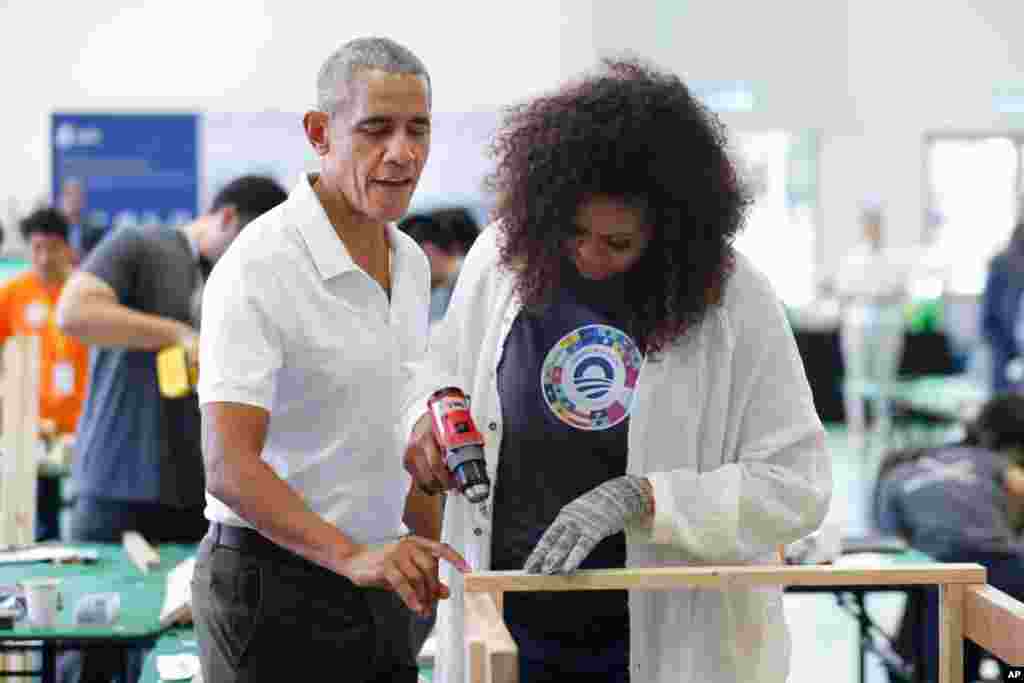 Former U.S. President Barack Obama and former first lady Michelle participate in a community service event at the Obama Foundation in Kuala Lumpur, Malaysia.