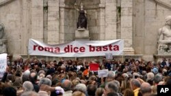 Rome residents, fed up with what they say is the ongoing decay of the city, rally in front of the city's Campidoglio Capitol Hill, Oct. 27, 2018. The banner reads "Rome Says Enough." 