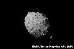 FILE - This image provided by NASA shows the asteroid Dimorphos, captured by NASA’s DART mission just two seconds before the spacecraft struck its surface, Sept. 26, 2022.