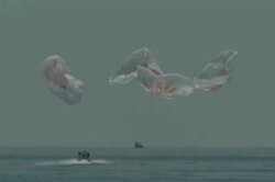 In this frame grab from NASA TV, the SpaceX Dragon capsule splashes down Aug. 2, 2020, in the Gulf of Mexico.