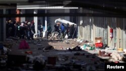 Demonstrators loot stores as protests continue, following imprisonment of former South Africa President Jacob Zuma, in Katlehong, South Africa, July 12, 2021. REUTERS/Siphiwe Sibeko