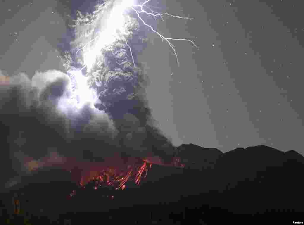 Volcanic lightning over Mount Sakurajima is pictured from Tarumizu city, Kagoshima prefecture, Japan, Dec. 17, 2020.