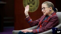 Supreme Court Justice Ruth Bader Ginsburg waves goodbye to those who came to listen and participate in her "fireside chat" in the Bruce M. Selya Appellate Courtroom at the Roger William University Law School in Bristol, Rhode Island, Jan. 30, 2018.