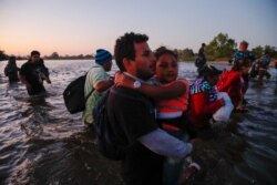 Central American migrants cross the Suchiate River from Tecun Uman, Guatemala, to Mexico, Jan. 23, 2020.