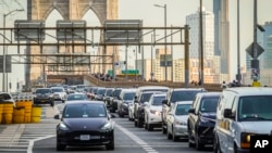 FILE - Traffic enters lower Manhattan after crossing the Brooklyn Bridge, Feb. 8, 2024, in New York. New York’s new toll for drivers entering the center of Manhattan debuted on Jan. 5, 2025.